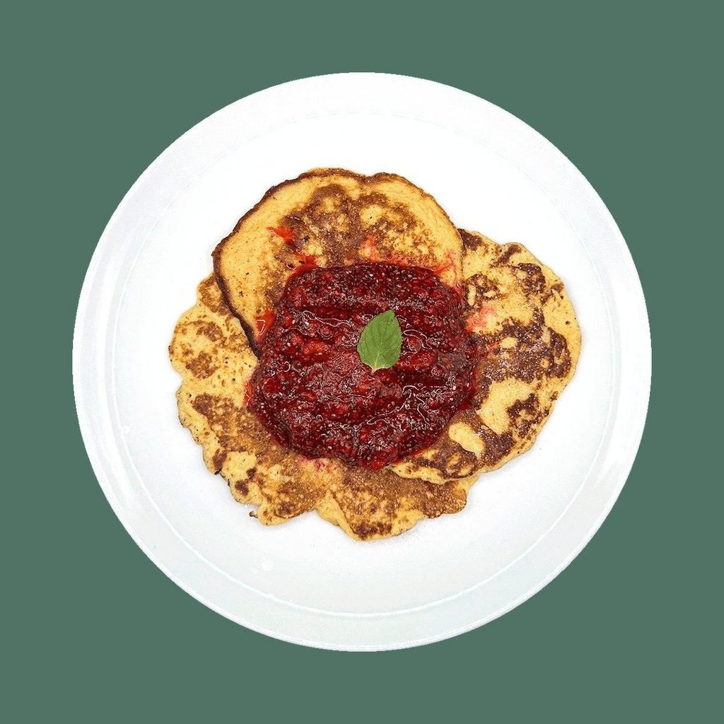 Keto palačinke od sitnog sira sa džemom od malina i čia semenki, na belom tanjiru